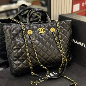 *CHANEL* 
*Large Coco Allure Shopping Tote* features black quilted leather and antiqued gold-tone hardware.
Quilted leather, chain-link straps, and gold CC logo
Exterior ConditionLeather Structure: The black quilted leather maintains its shape well. 
Hardware: The antiqued gold-tone CC logo and chain straps show strong color clarity with minimal visible tarnishing or scratches.
Accessories & Interior Included Pouch: The removable leopard-print canvas pouch shown in the foreground appears clean, with its gold zipper intact and functional.
Brand Dust Bag and Brand Box Included